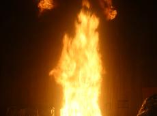 Tall flames from burning crib extending into the stack